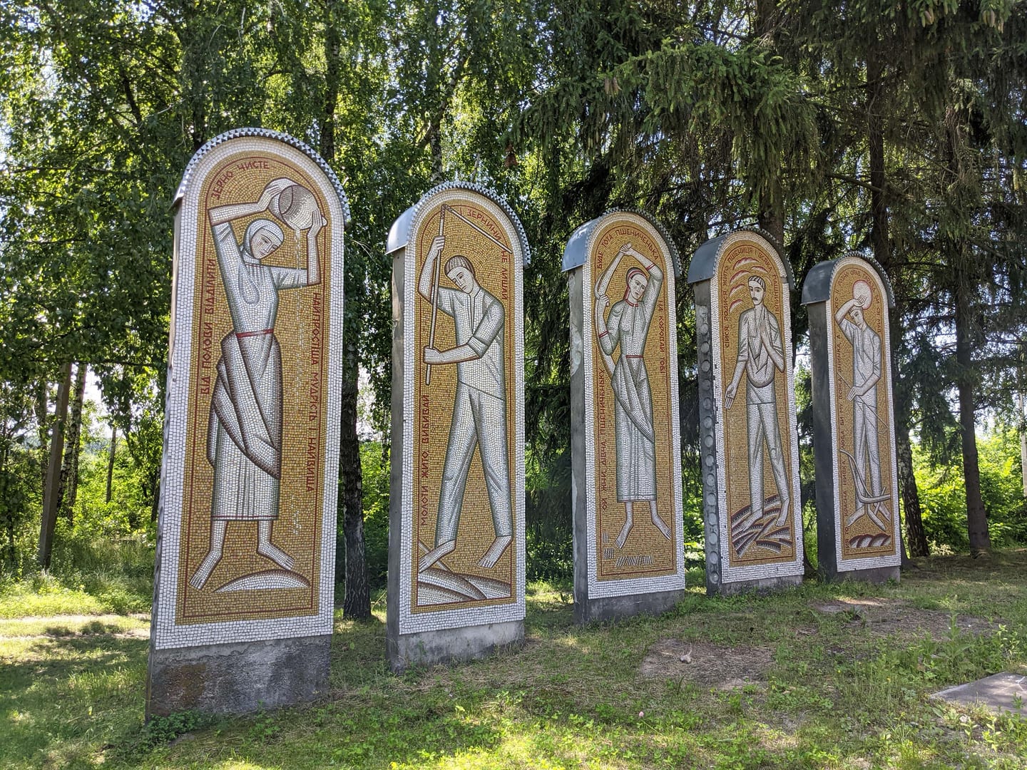Carved wooden statues among the trees at the Pereiaslav folk museum